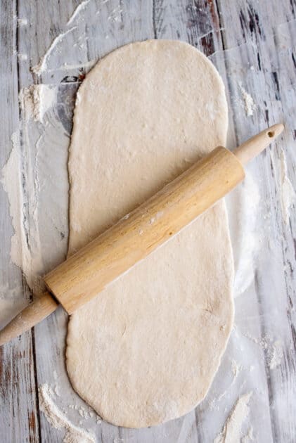 Roll out dough with rolling pin.