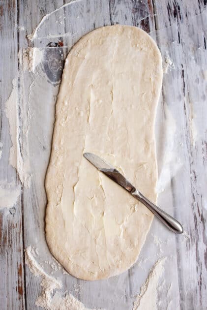 Spread butter over dough.