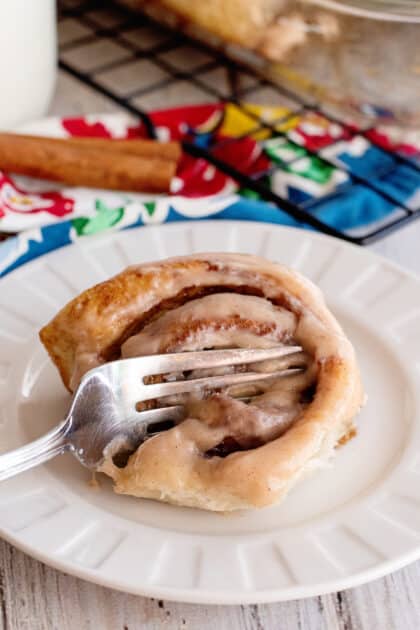 Fork digging into an easy homemade cinnamon roll.
