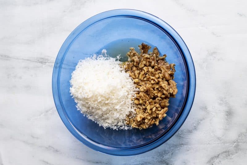 Add coconut to mixing bowl.