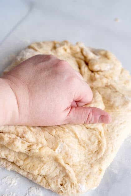 Knead yeast roll dough by hand.