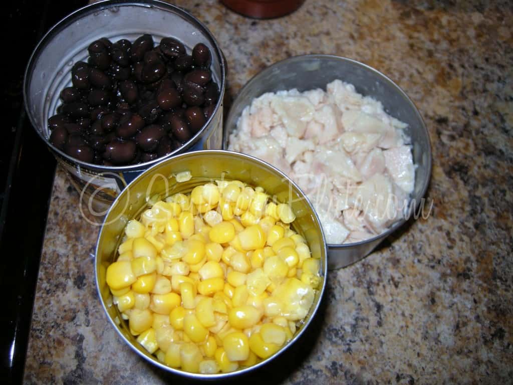 Drained chicken, corn, and black beans in bowls