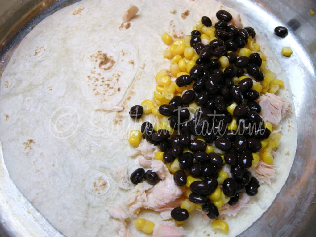Black beans added over the chicken and corn