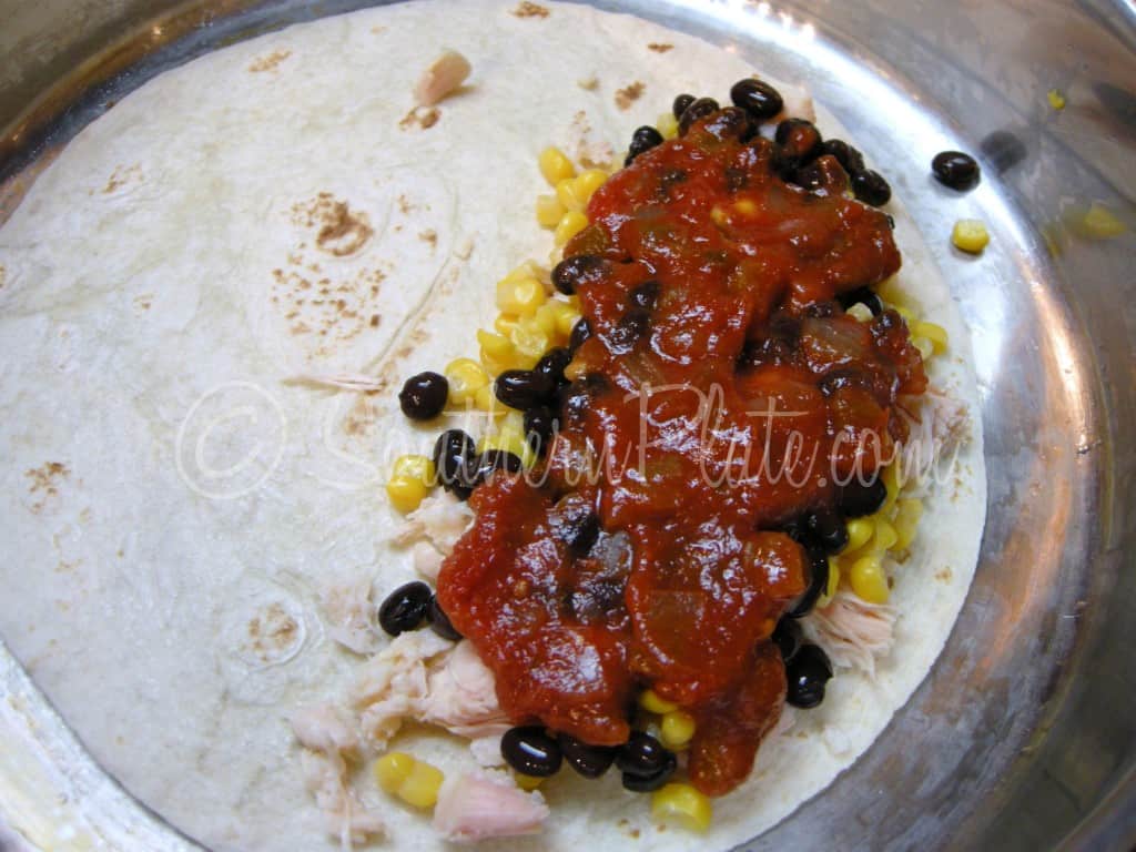 Salsa spooned over the quesadilla filling