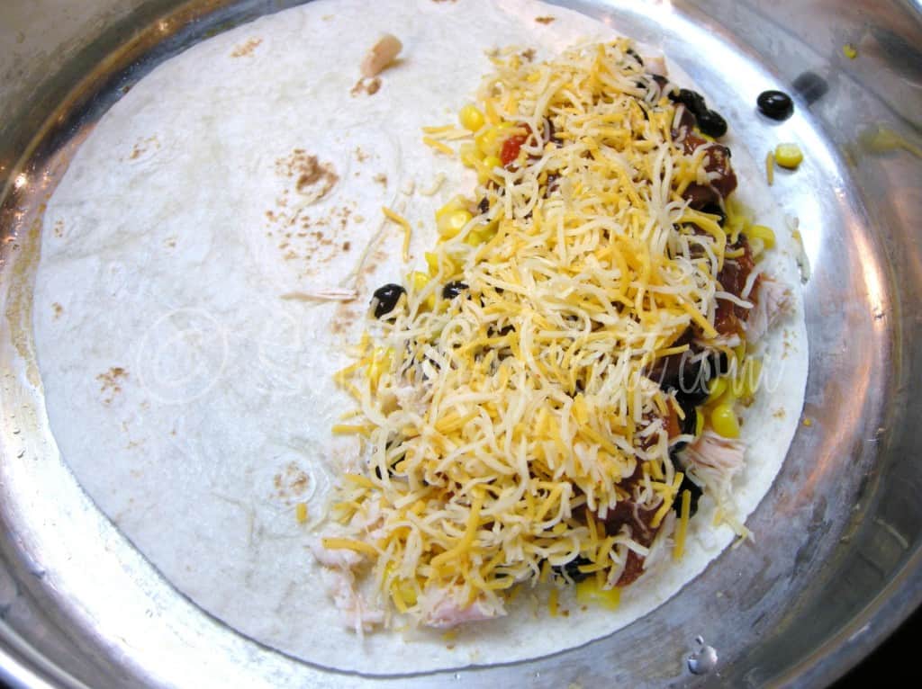 Shredded cheese sprinkled over the filling