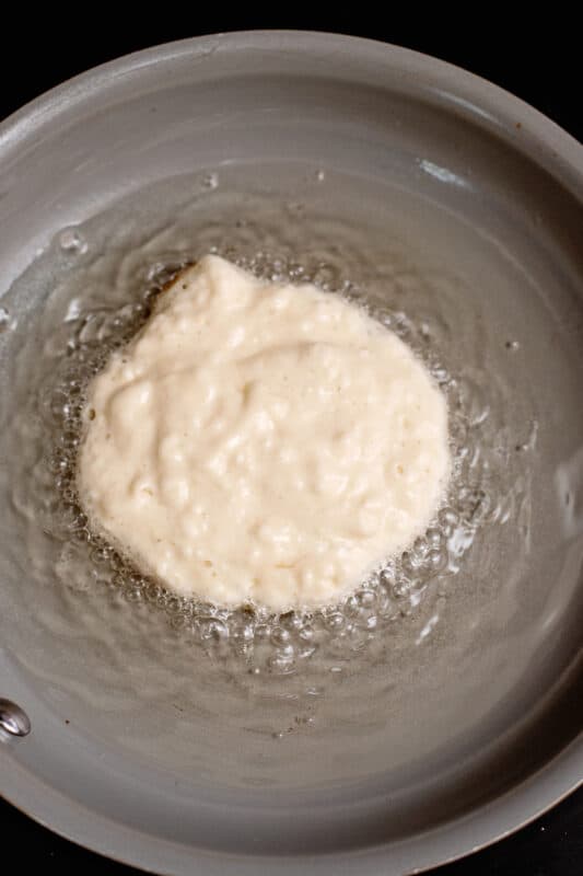 Pancake batter in oil.