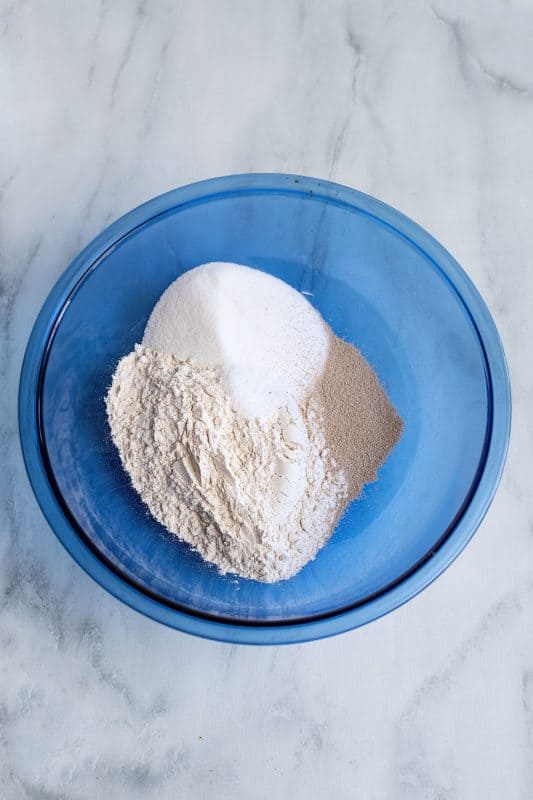 Measure your sugar, salt, all-purpose flour, and yeast into a mixing bowl.