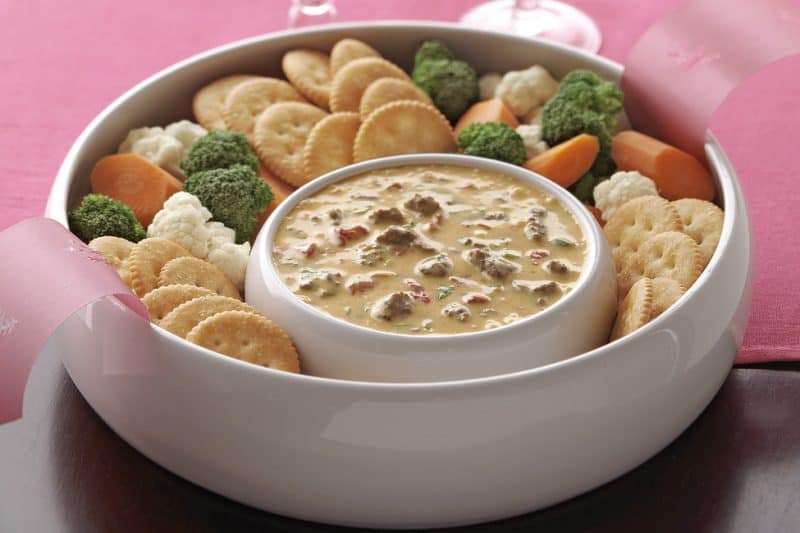 Velveeta Spicy Cheeseburger Dip served with veggies and crackers.