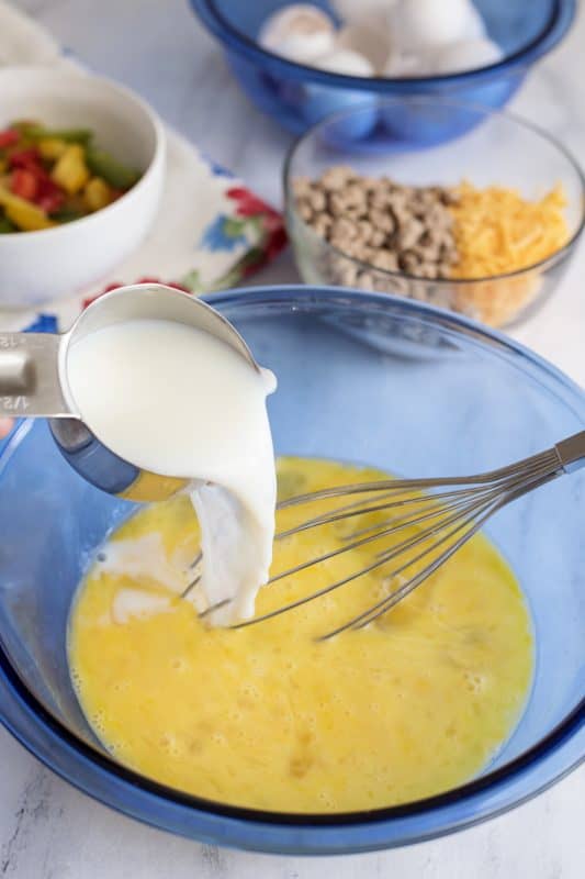 Add milk to eggs in mixing bowl.