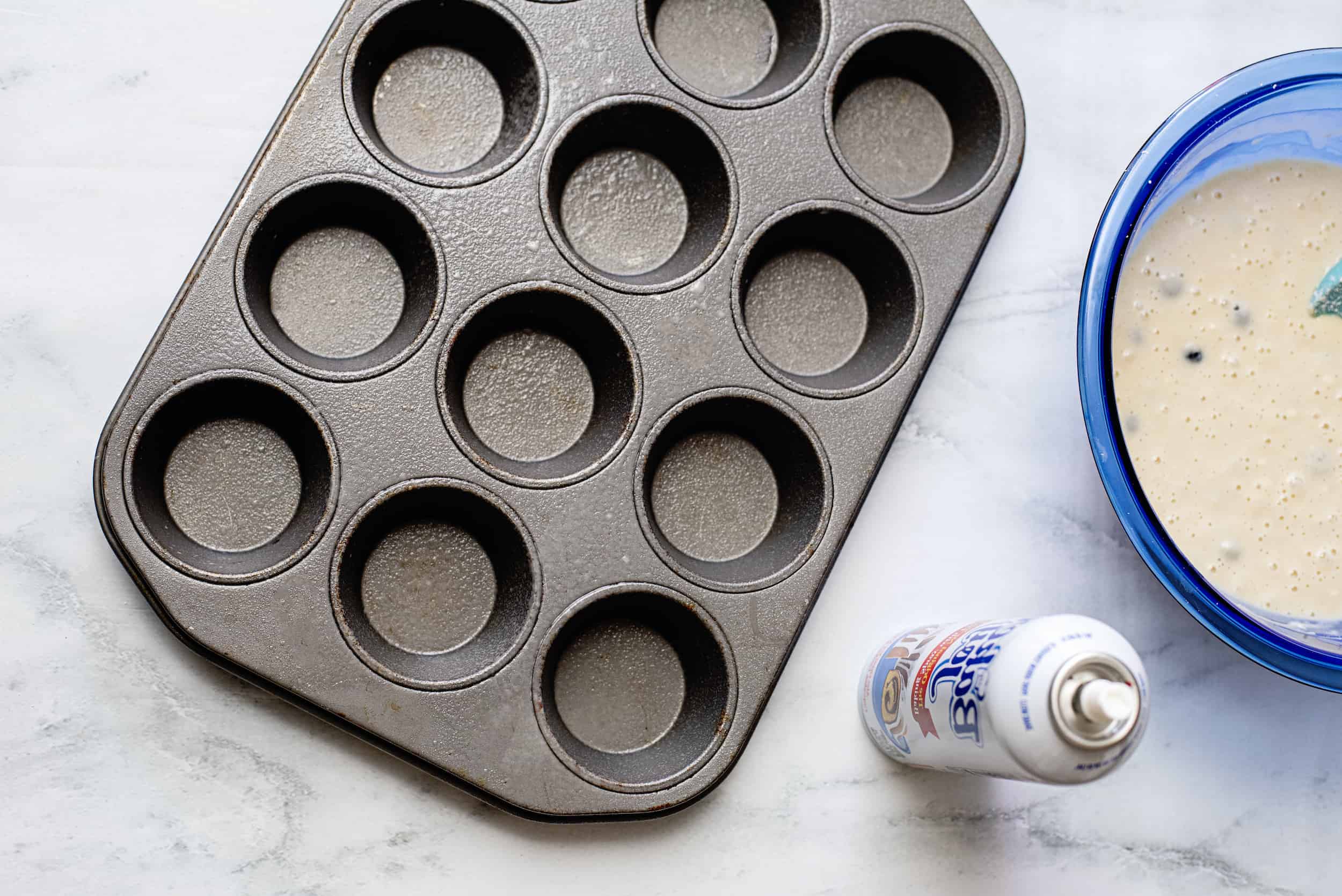 Spray muffin pan with cooking spray.