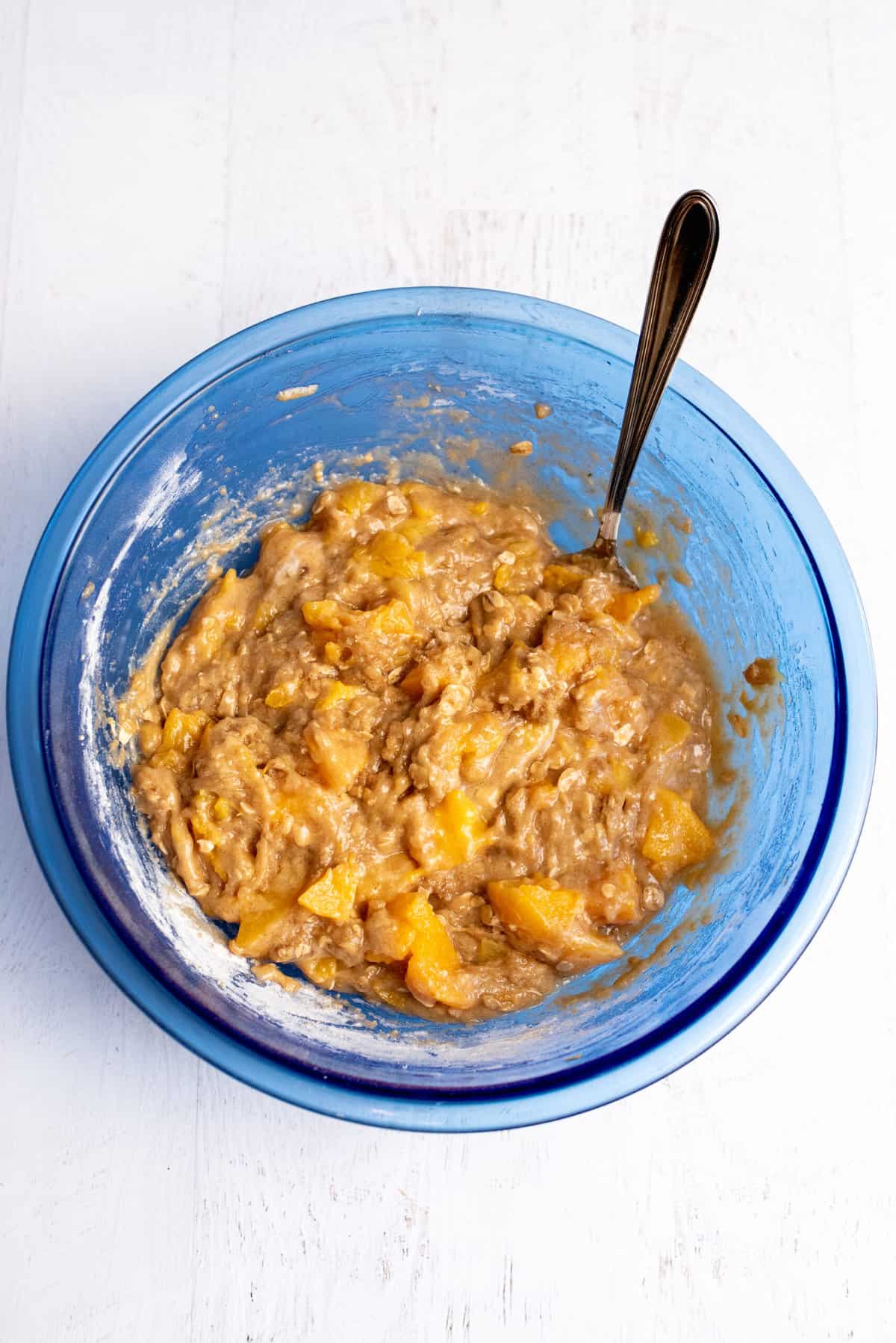 mix dry and wet ingredients for peach cobbler muffins together
