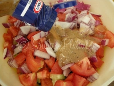 Add the whole dressing bottle to the bowl.