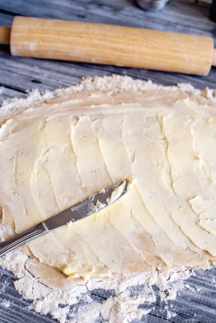 Spread butter on dough.