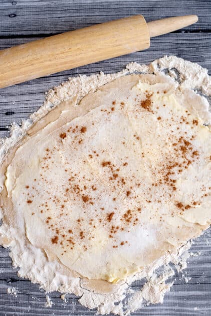 Add cinnamon to rolled-out dough.