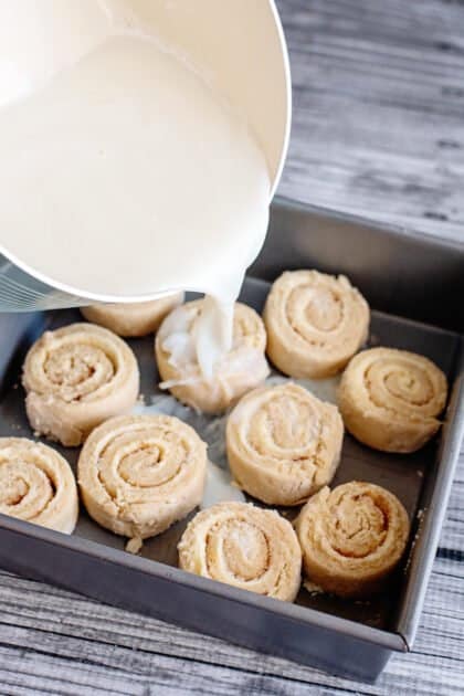 Pour milk sauce over old-fashioned butter rolls.