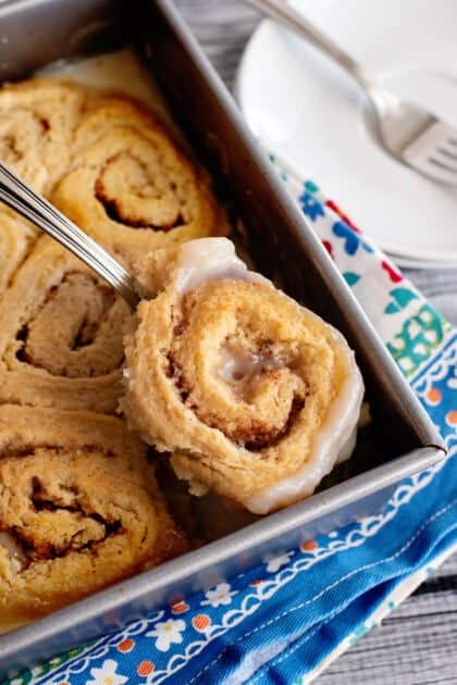 Taking butter roll out of pan.