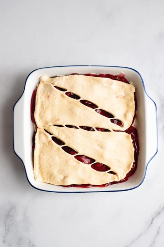top the cherries with the other half of crescent roll