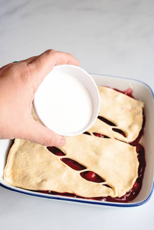 sprinkle sugar on top of the cherry cream cheese cobbler