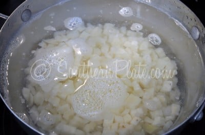 Place cubed hash browns in a large pot and cover with water.