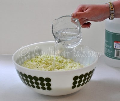 Add vinegar and cabbage to mixing bowl.