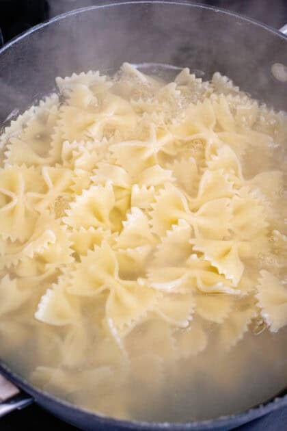Bowtie pasta boiling in water.