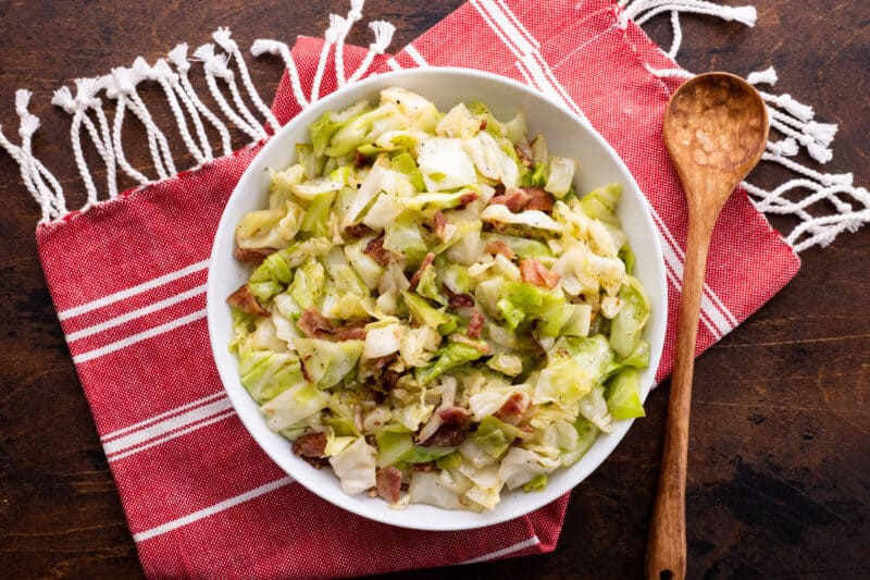 Fried cabbage with bacon in large serving bowl