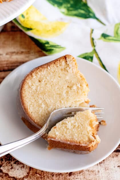Fork breaking off a piece of 7-Up pound cake.