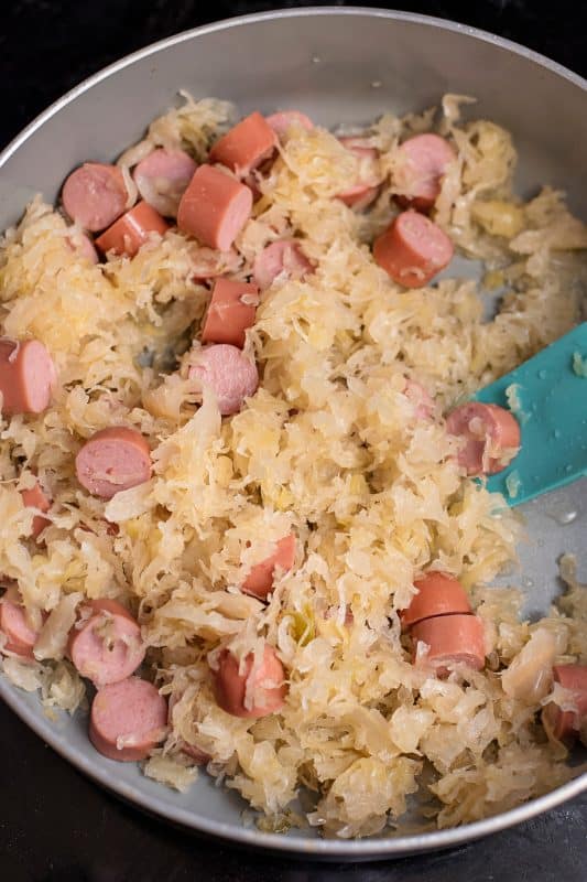 Add sauerkraut and cook, stirring often.