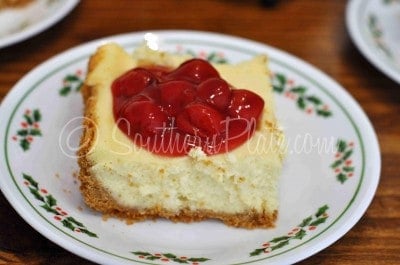 Cheesecake slice with cherry pie filling.