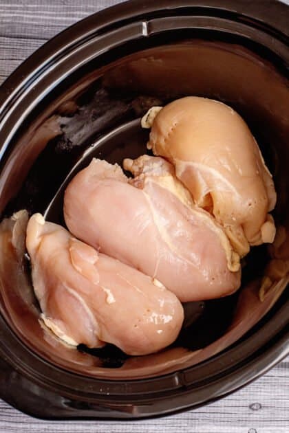 Place chicken in the bottom of the slow cooker.
