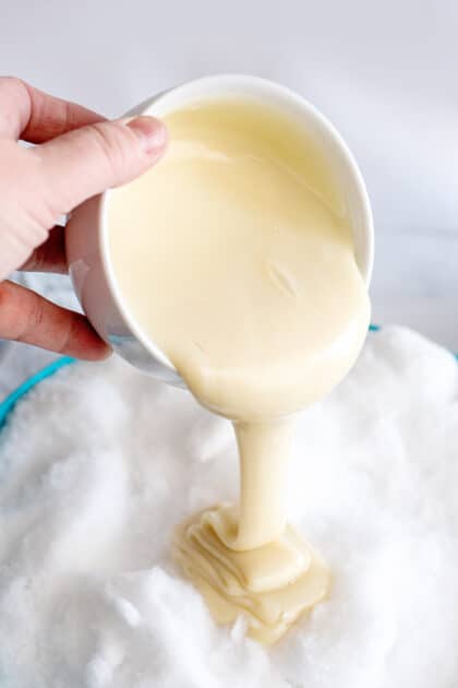 Pour sweetened condensed milk over the snow.