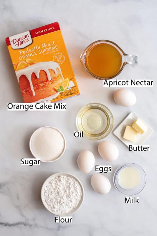 Labeled ingredients for easy orange cake recipe.