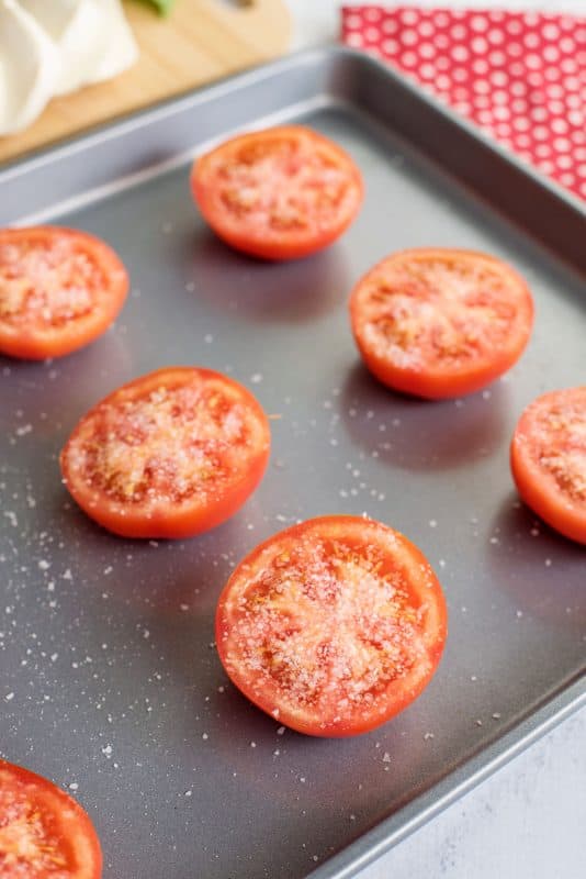 Sprinkle tomato halves with salt.