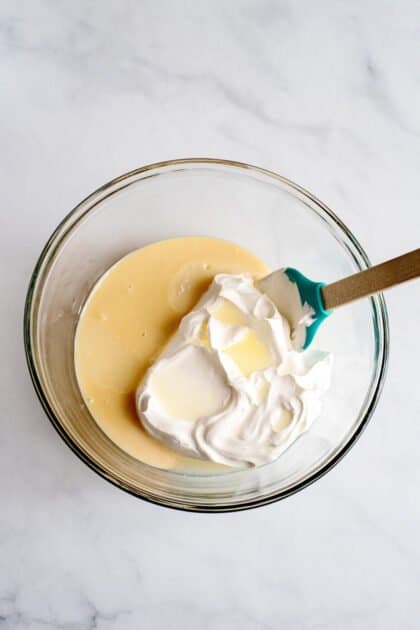 Place your sweetened condensed milk, whipped topping, and lemon juice in a medium bowl.