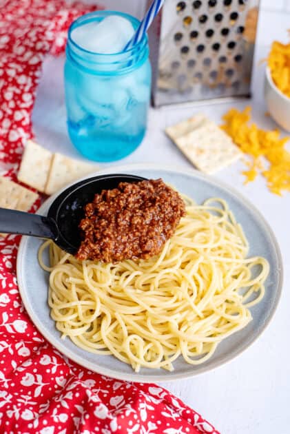 Top spaghetti with a spoonful of chili.