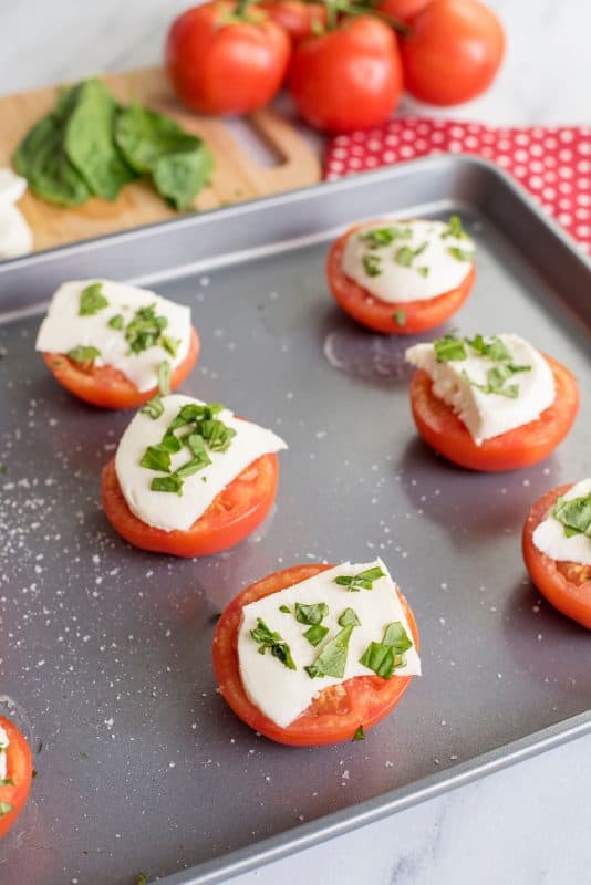 Baked tomatoes with mozzarella and basil.