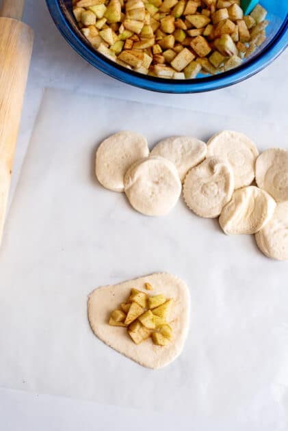 Place apple filling in center of biscuit dough.