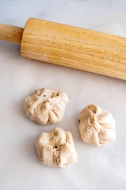 Fold up sides of biscuit dough to create apple dumpling.