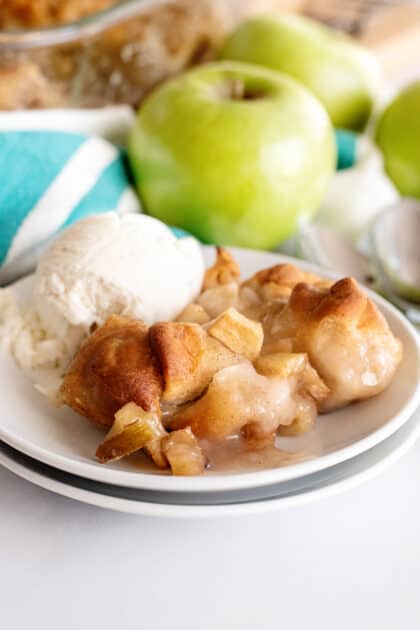 Apple dumplings on plate with ice cream.