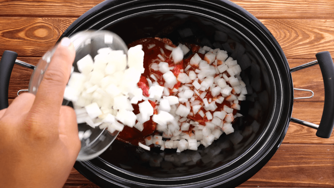 Add diced onion to slow cooker.