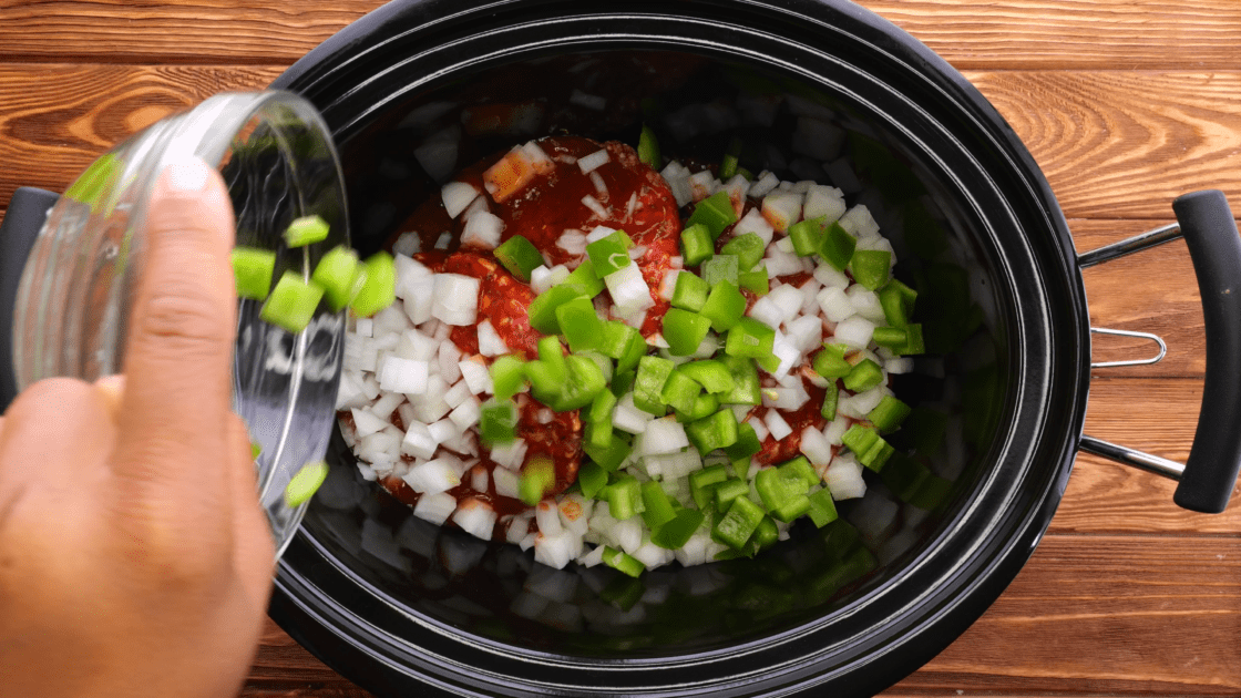 Add diced bell pepper to slow cooker.