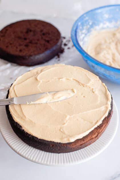 Add icing to the first cappuccino cake layer.