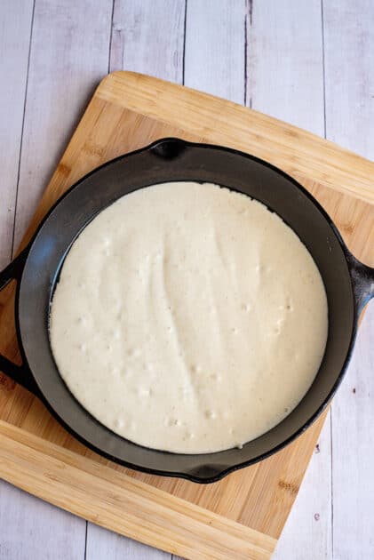Mixed cornbread mix in a 10 1/2 inch cast iron skillet