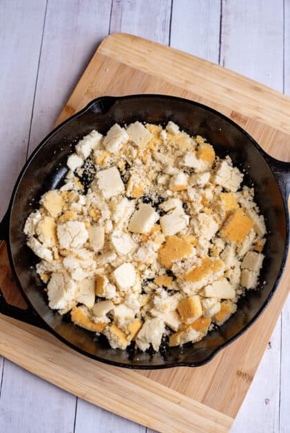Chopped, baked cornbread cubes in a cast iron skillet for monte cristo skillet