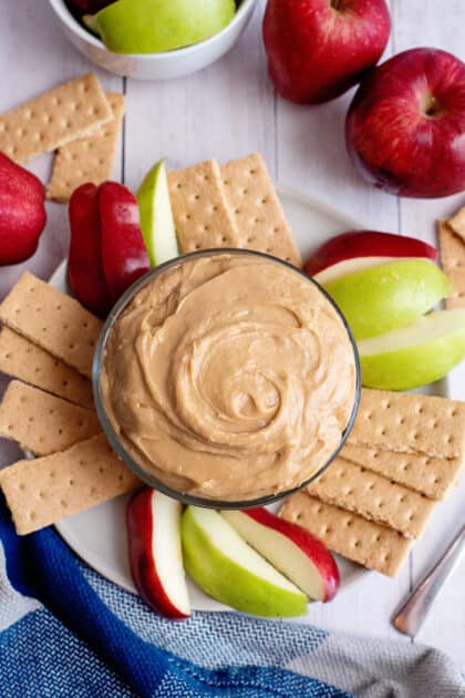 peanut butter dip with apple slices and graham crackers