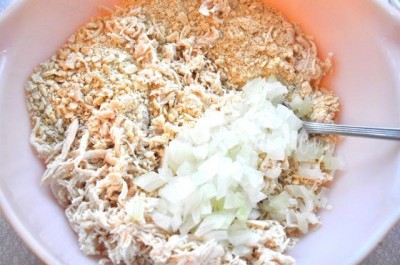 In a separate bowl, place chicken, cracker crumbs, and onion.