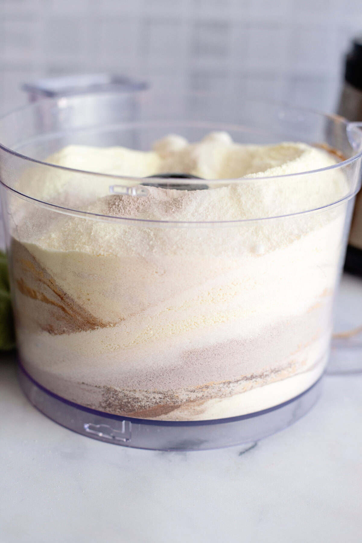 A swirl of vanilla chai powder mix in a food processor.