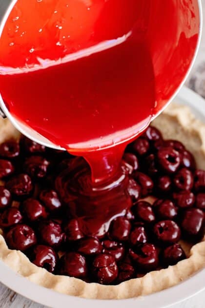 Pour filling over cherries.