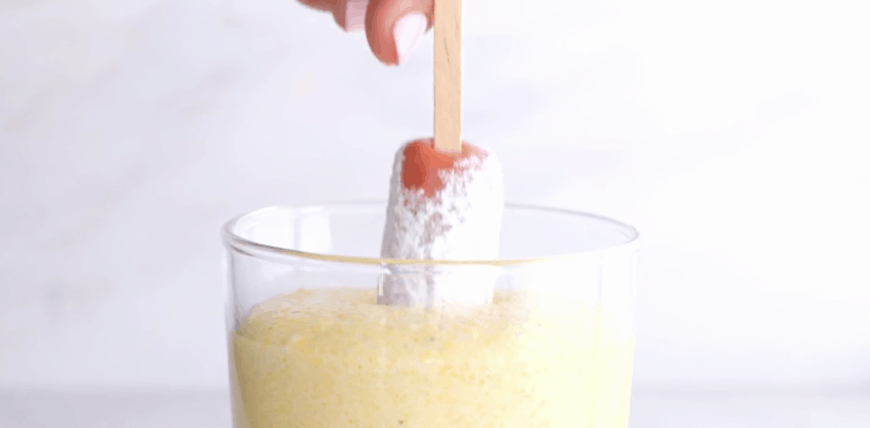 pour batter for the corn dogs into tall drinking glass