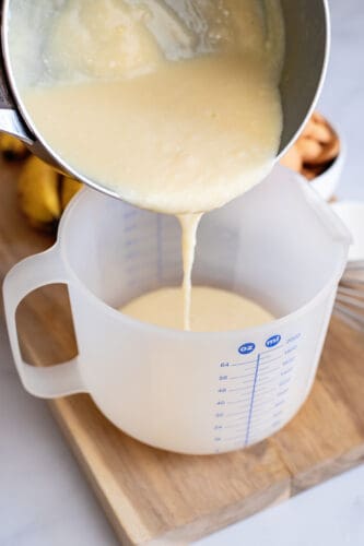 Pouring pudding mixture into batter bowl.